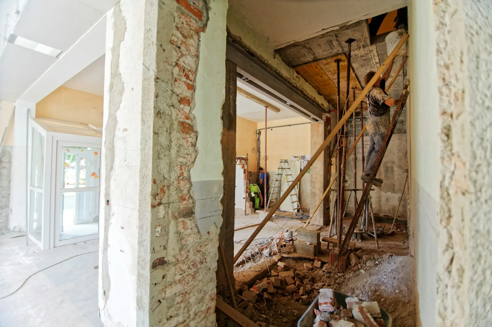 Residential interior mid-renovation with exposed brickwork